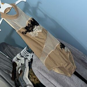 Nude mesh leotard with appliqués. Halter top